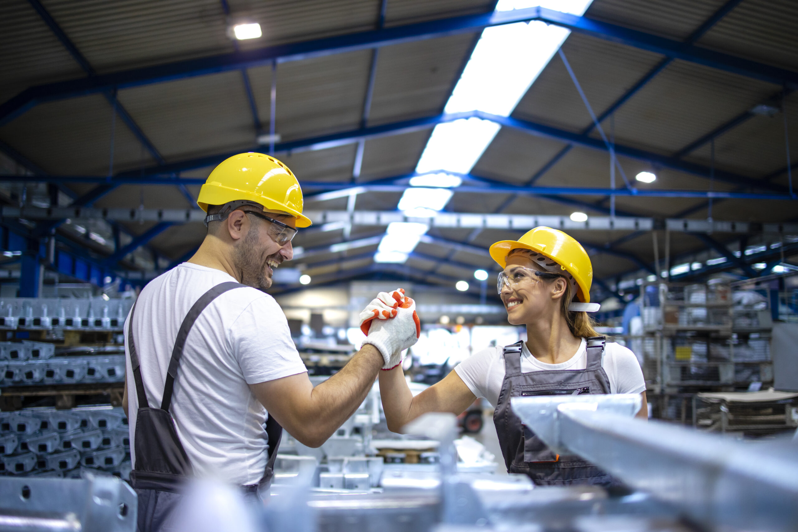 Factory workers handshaking each other production line scaled