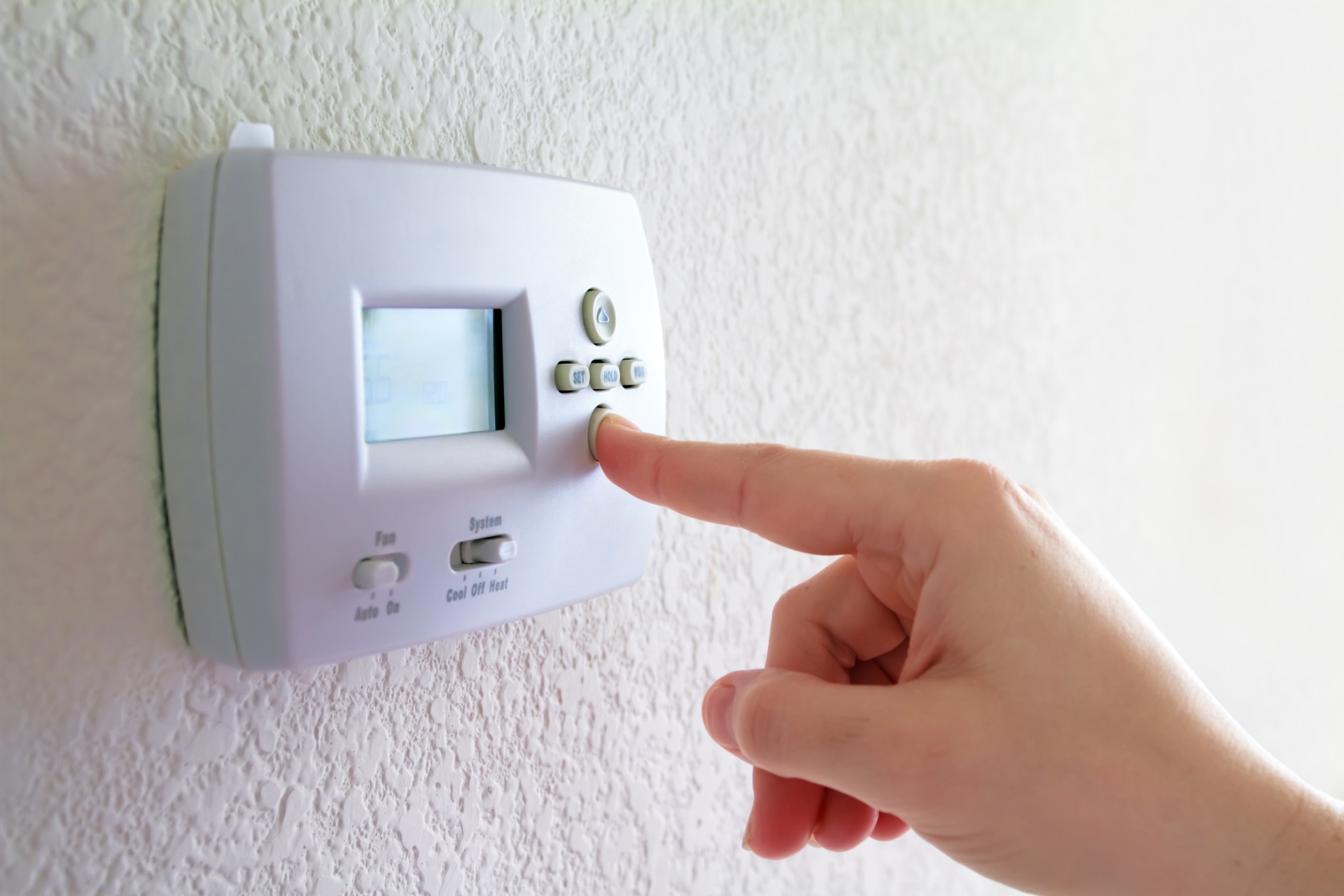 Someone turns down the temperature on the thermostat