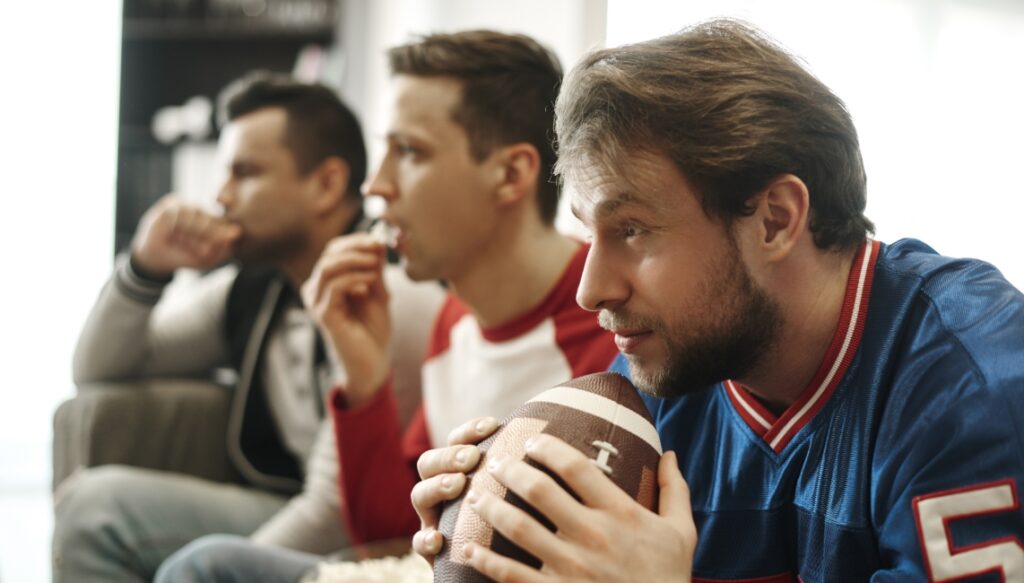 Three guys watching a football game