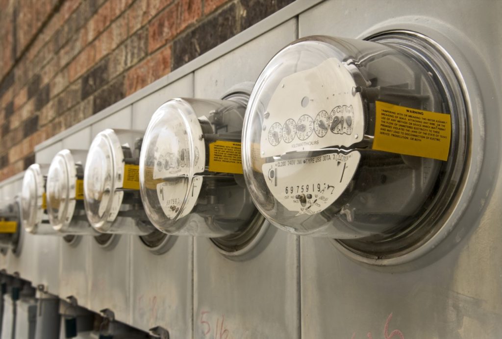 Traditional analog electric meters in a row