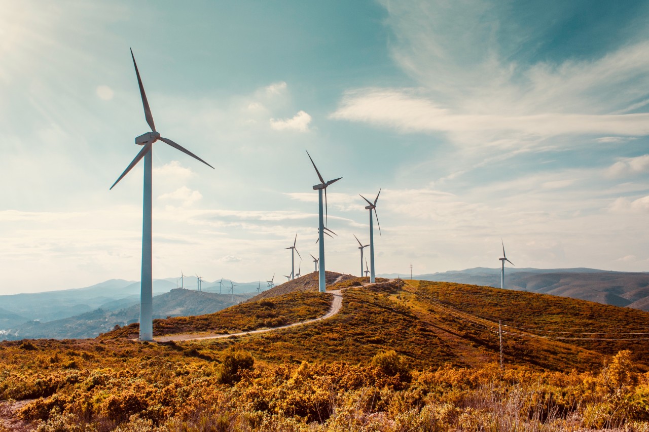 Wind turbines brown mountain range